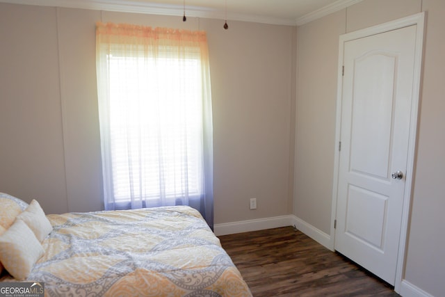 bedroom with crown molding, dark wood-style floors, and baseboards