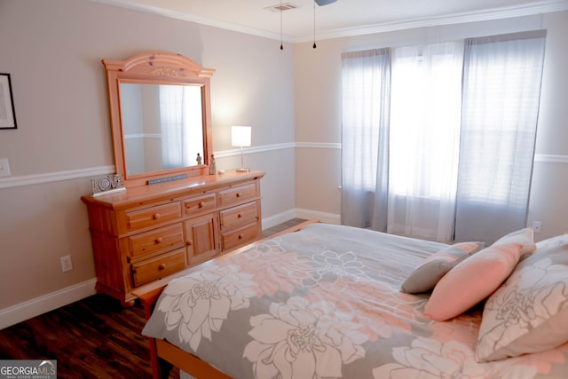 bedroom with visible vents, dark wood-type flooring, baseboards, and ornamental molding