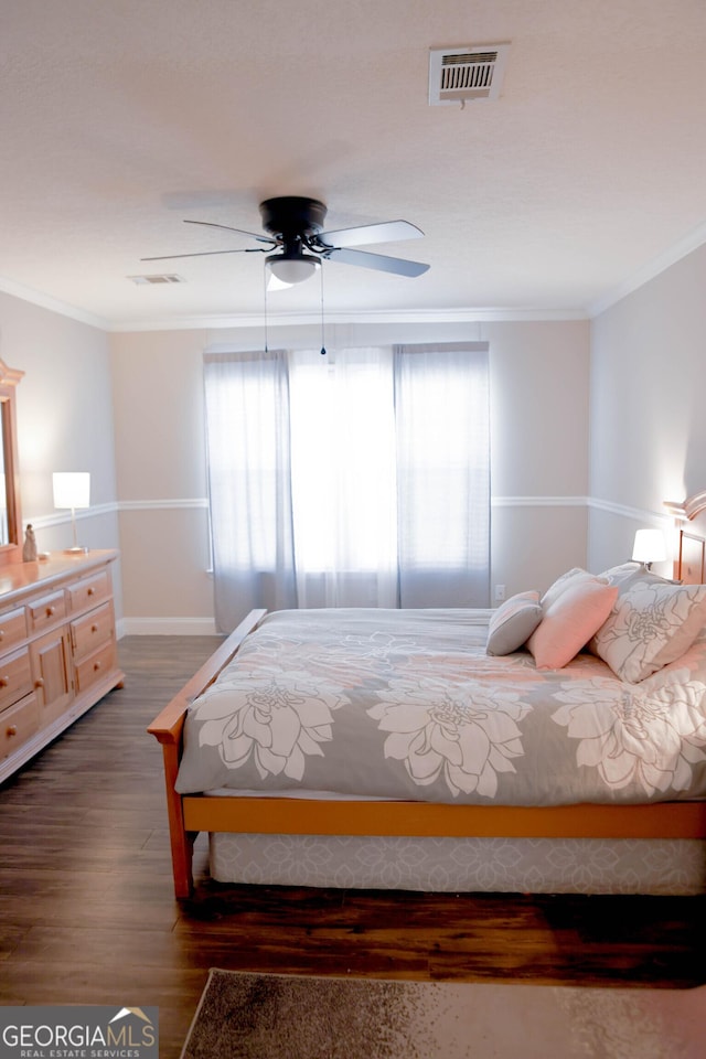 bedroom featuring visible vents, multiple windows, and crown molding