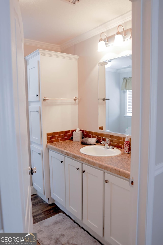 bathroom with tasteful backsplash, vanity, and ornamental molding