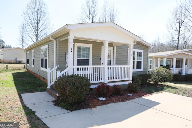 view of front of home featuring crawl space and a porch