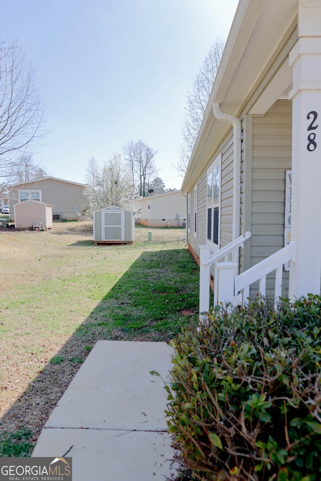 view of yard with a storage unit, central air condition unit, a patio, and an outdoor structure