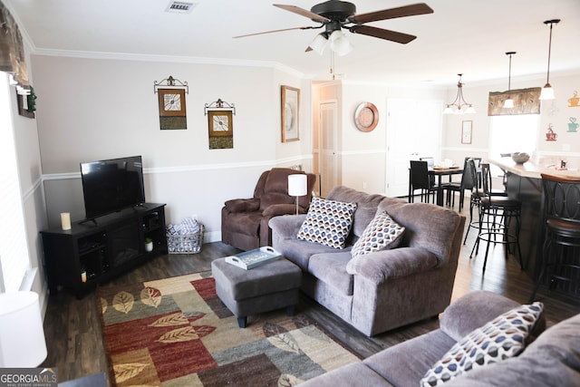 living room featuring crown molding, wood finished floors, visible vents, and ceiling fan