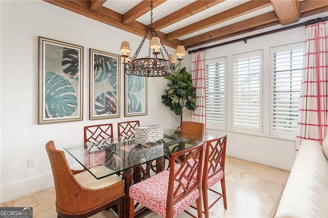 dining room with beamed ceiling, baseboards, and an inviting chandelier