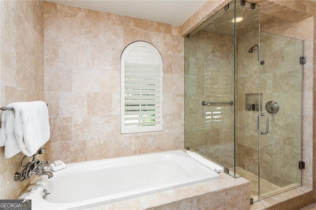 bathroom with a garden tub and a shower stall