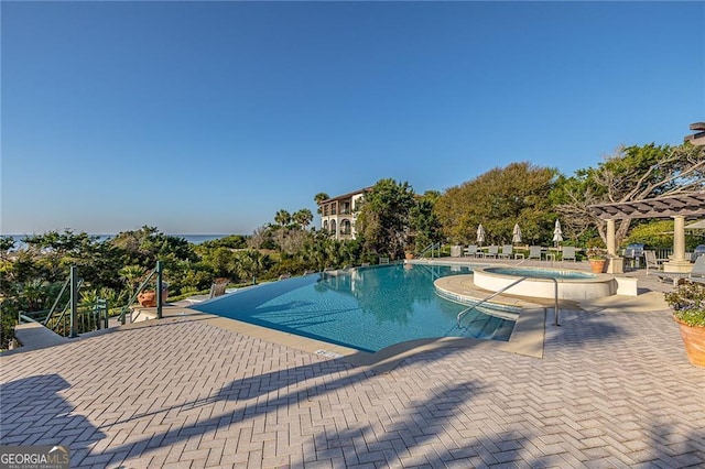 community pool with a patio and a pergola