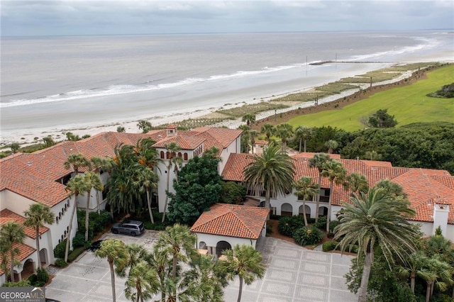 drone / aerial view featuring a view of the beach and a water view