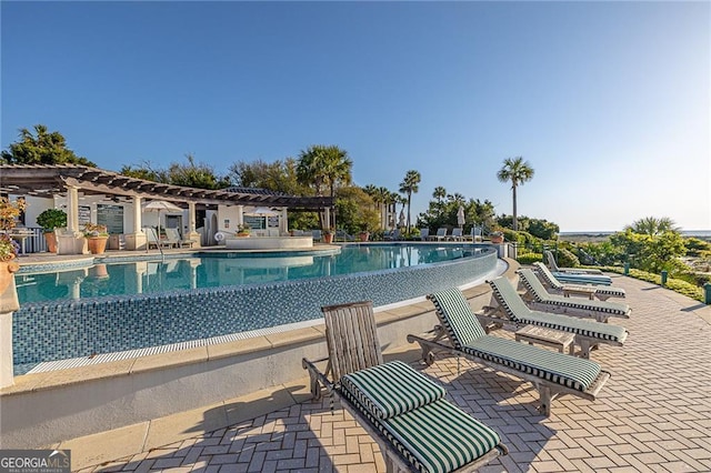 community pool featuring a pergola and a patio