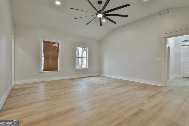 spare room with visible vents, light wood-style floors, a ceiling fan, and vaulted ceiling