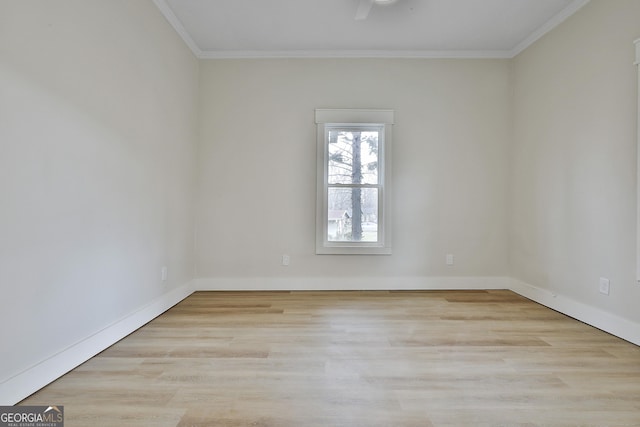 unfurnished room with wood finished floors, baseboards, and ornamental molding