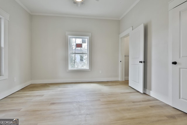 unfurnished bedroom featuring crown molding, baseboards, and light wood-type flooring