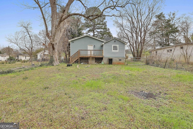 rear view of house with fence, stairs, crawl space, a deck, and a lawn