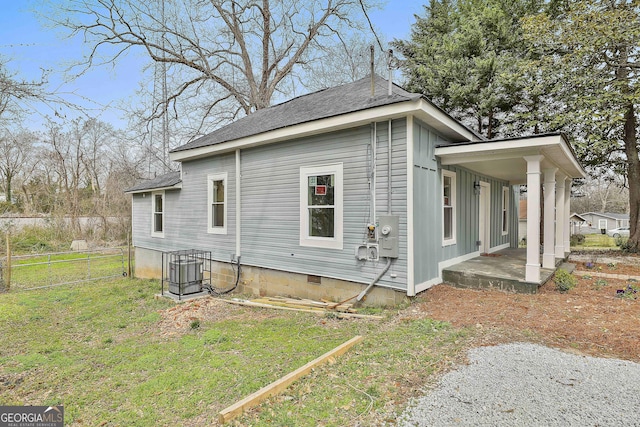 view of home's exterior featuring crawl space, fence, a lawn, and a shingled roof