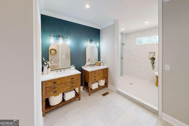 full bathroom featuring vanity, baseboards, visible vents, and a tile shower