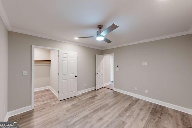 unfurnished bedroom with baseboards, light wood-style floors, and crown molding