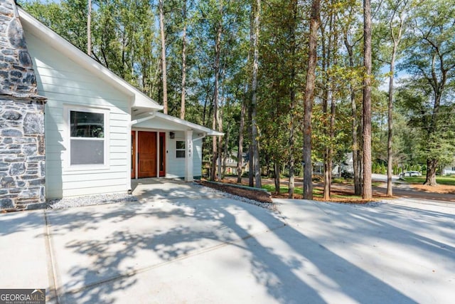 view of side of home featuring stone siding