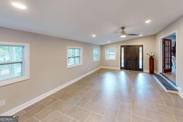 foyer with baseboards, a wealth of natural light, and ceiling fan