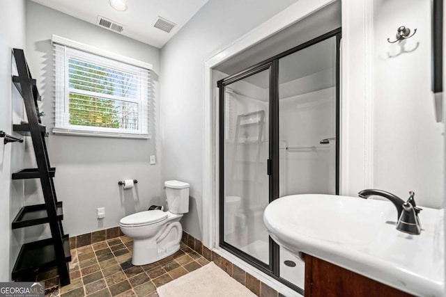 full bathroom with visible vents, a stall shower, toilet, and baseboards