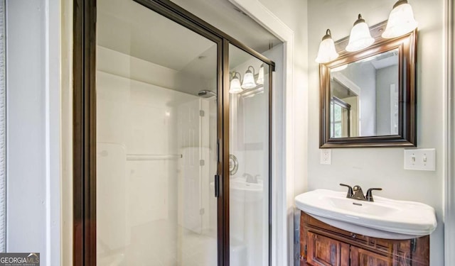 full bathroom with a stall shower and vanity