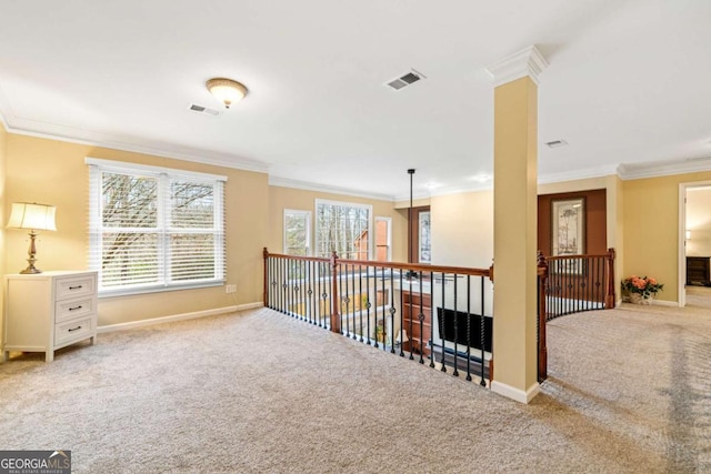 hall with visible vents, crown molding, and carpet floors