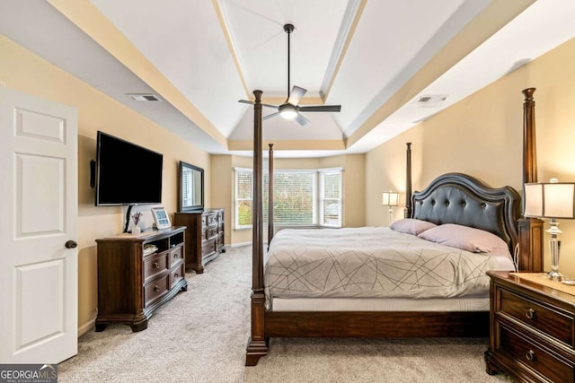 bedroom featuring visible vents, lofted ceiling, light colored carpet, and baseboards