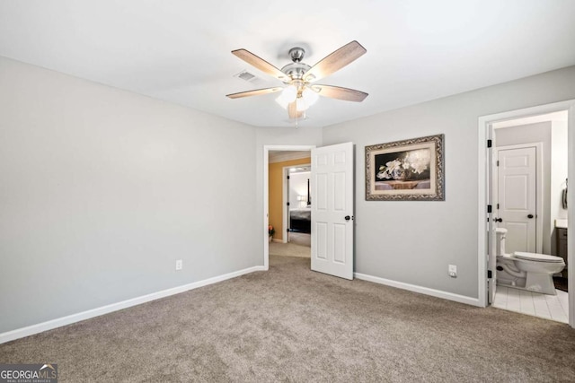 unfurnished bedroom featuring ensuite bath, carpet, baseboards, and visible vents