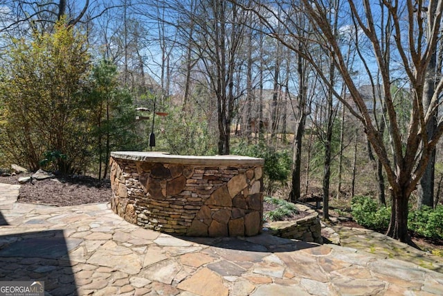 view of patio / terrace with a wooded view