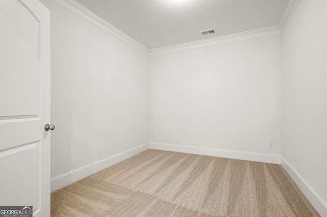 unfurnished room with visible vents, ornamental molding, baseboards, and carpet floors