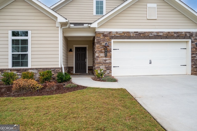 view of front of property featuring stone siding, a front lawn, concrete driveway, and a garage