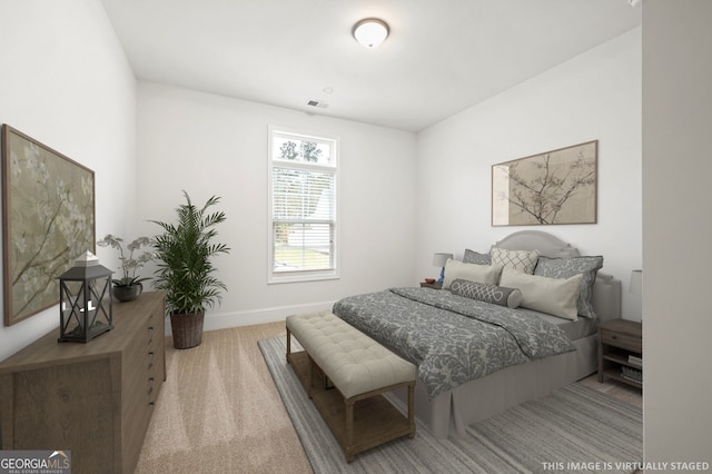 carpeted bedroom with visible vents and baseboards