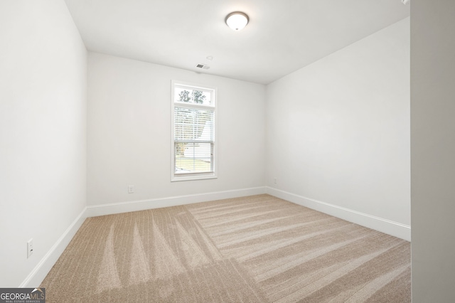 unfurnished room featuring visible vents, baseboards, and carpet