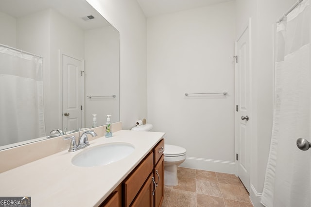 bathroom featuring visible vents, toilet, vanity, and baseboards