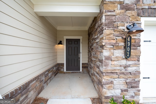 property entrance with stone siding