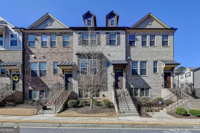 townhome / multi-family property featuring brick siding