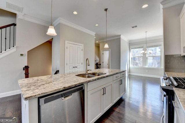 kitchen featuring a sink, stainless steel appliances, tasteful backsplash, and visible vents