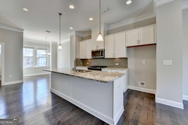 kitchen with visible vents, a sink, white cabinetry, appliances with stainless steel finishes, and decorative backsplash