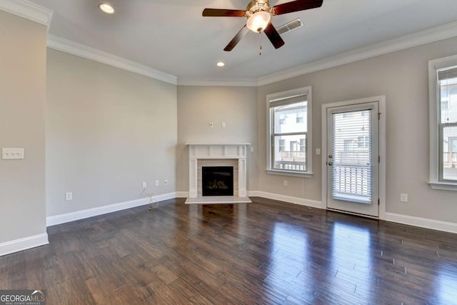 unfurnished living room featuring visible vents, crown molding, baseboards, ceiling fan, and wood finished floors