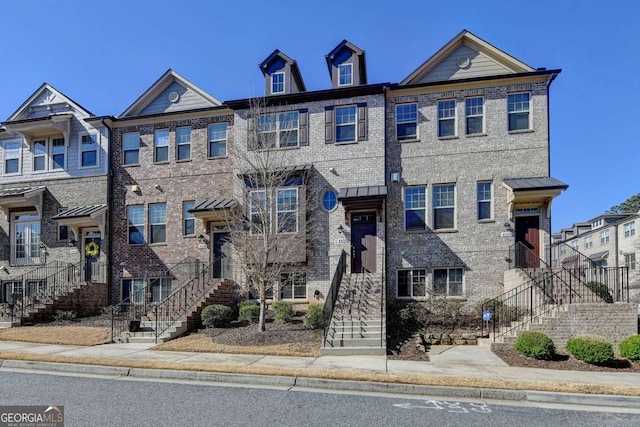 townhome / multi-family property with brick siding