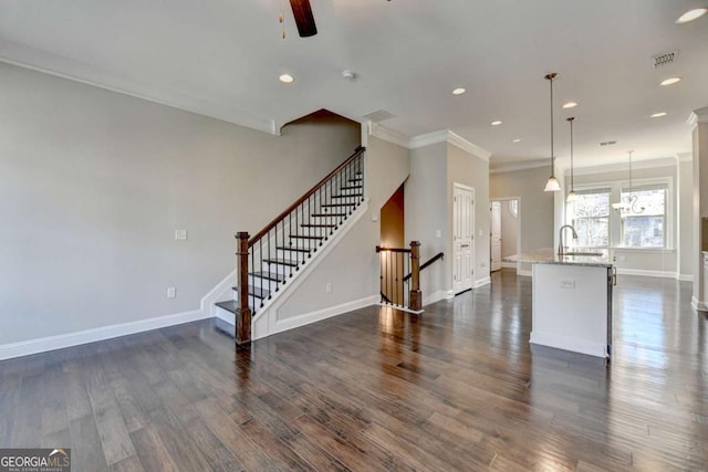 living room featuring stairs, visible vents, dark wood finished floors, and a ceiling fan