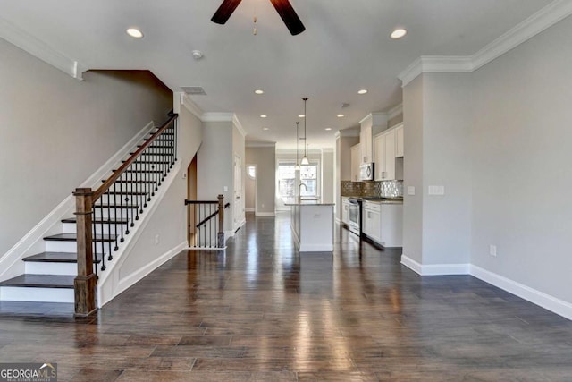 unfurnished living room featuring ceiling fan, baseboards, and dark wood-style floors