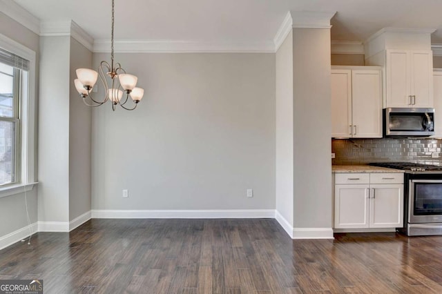 kitchen featuring plenty of natural light, backsplash, appliances with stainless steel finishes, and dark wood-style floors