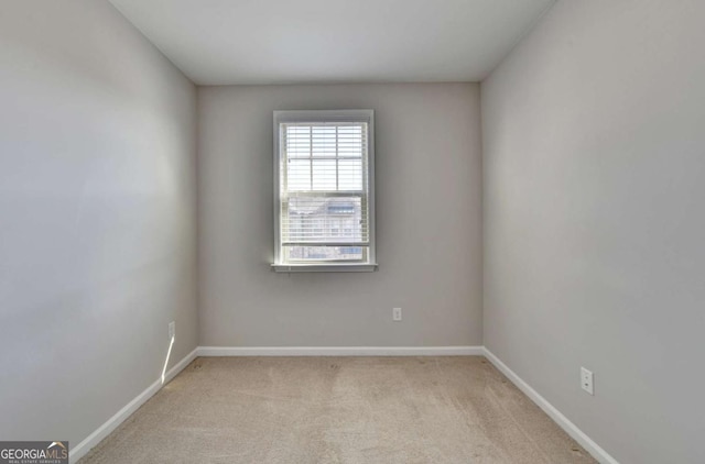 unfurnished room with baseboards and carpet floors