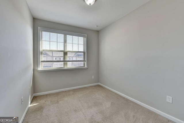 unfurnished room featuring baseboards and carpet floors