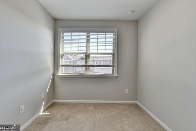 carpeted empty room with baseboards