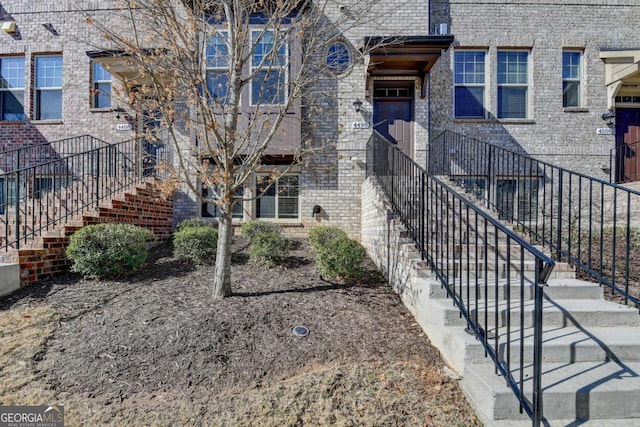 view of exterior entry featuring brick siding