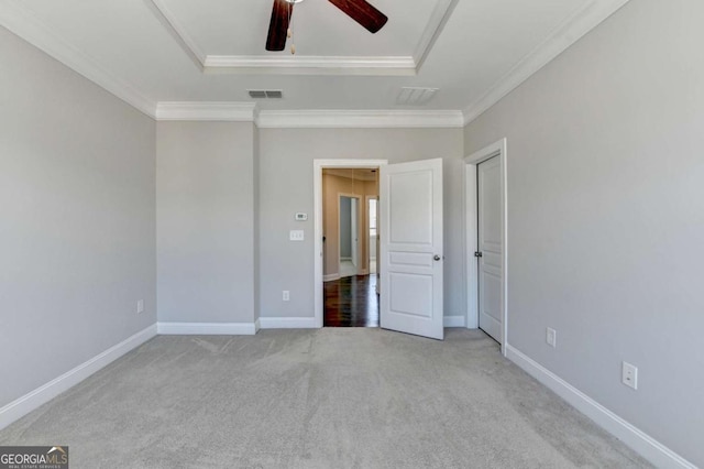 unfurnished bedroom featuring visible vents, baseboards, carpet flooring, and crown molding