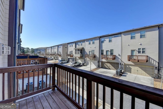 wooden deck featuring cooling unit and a residential view