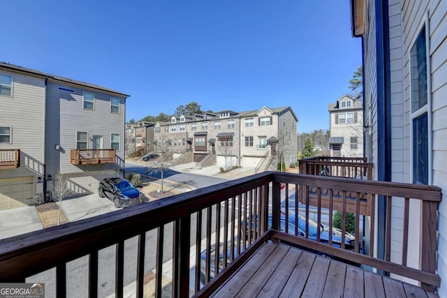 wooden terrace featuring a residential view