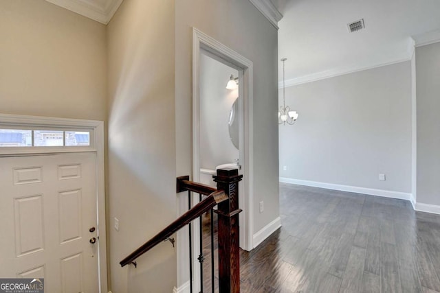 entrance foyer with baseboards, dark wood-style floors, visible vents, and ornamental molding