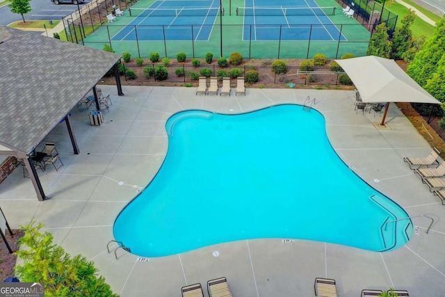 pool featuring a patio area and fence